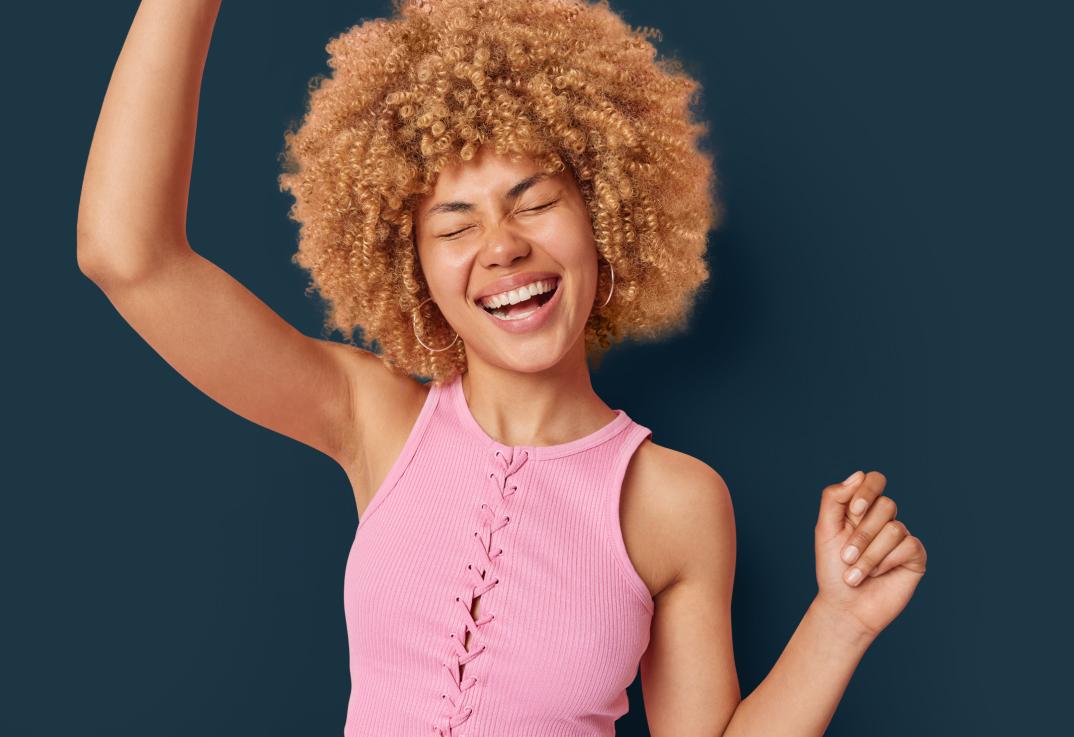 Woman raising her arms confidently
